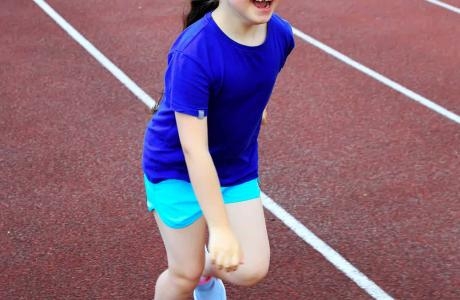 Girl with down syndrome running track
