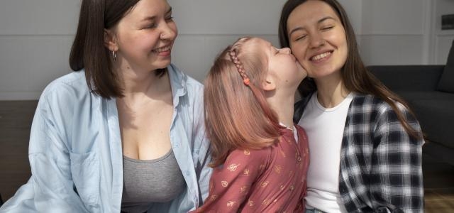 mommies spending time together with their daughter home scaled