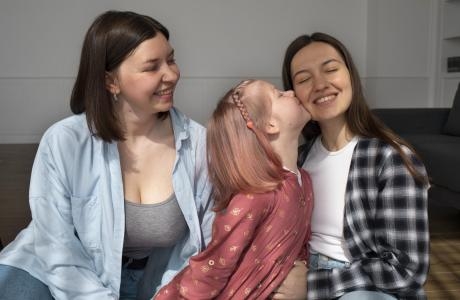 mommies spending time together with their daughter home scaled